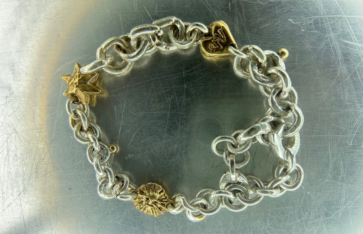 J's 14kt gold and .925 silver charm bracelet